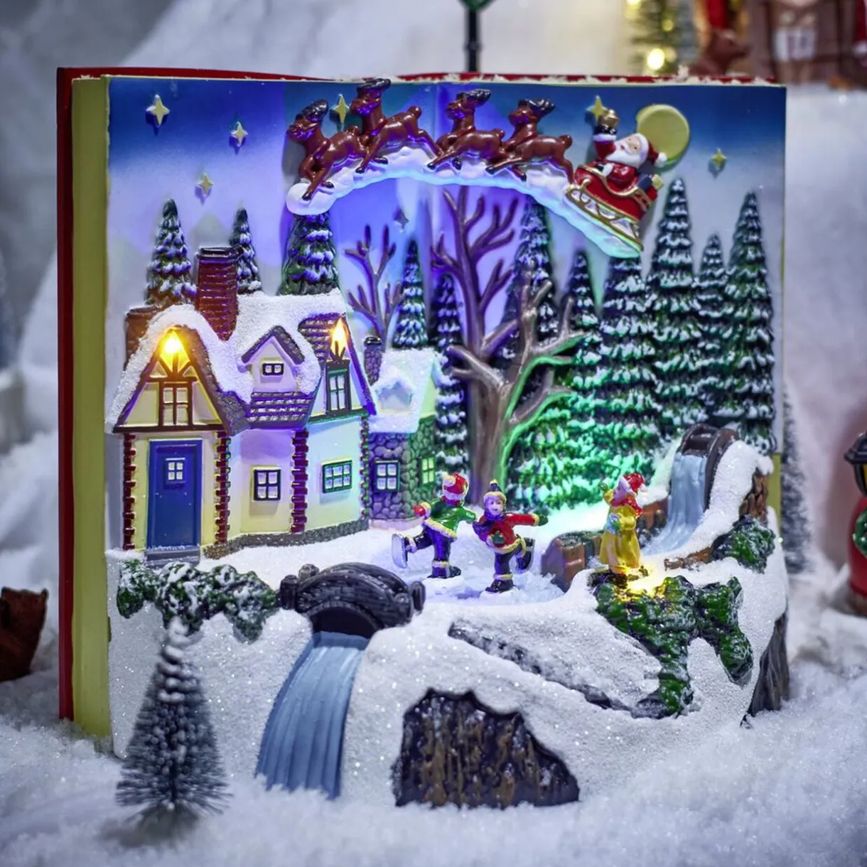 Village animé lumineux sonore façon livre ouvert avec enfants patinoire H20,5cm < Gifi Hot